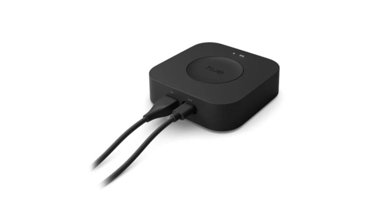 Philips Hue Bridge Pro with two cables connected on a white background