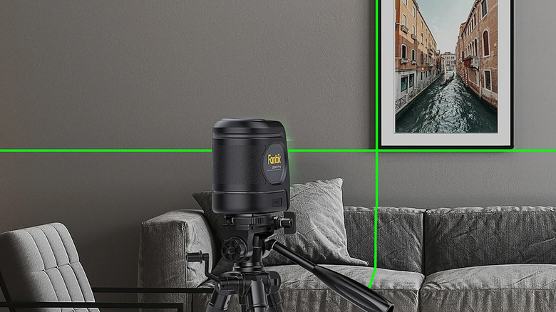 A Fanttik laser level projecting onto a living room wall.