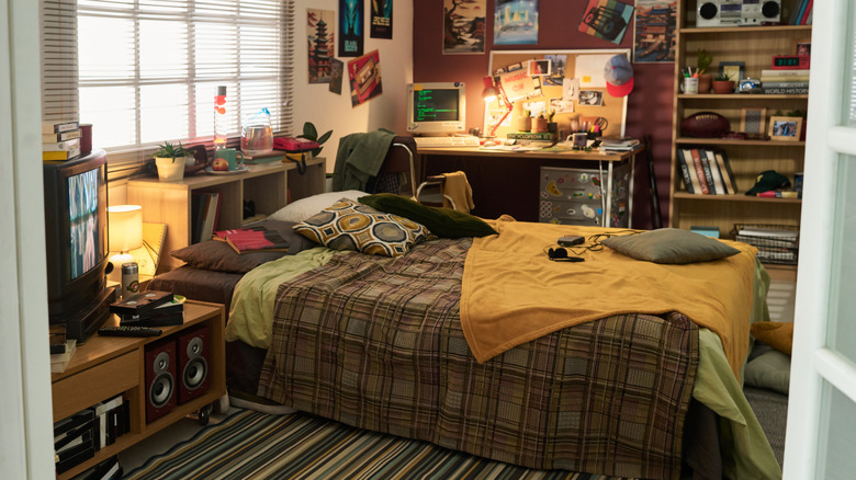 A cozy retro bedroom featuring many gadgets from the 80s