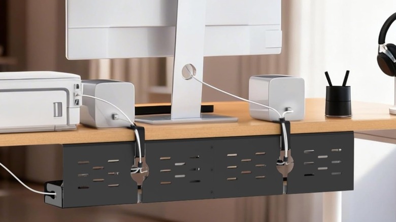 Univivi under desk cable management tray in use and clipped to bottom of workdesk.