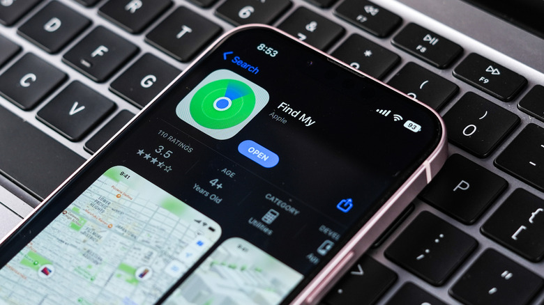 Apple Find my app on iPhone placed over a MacBook