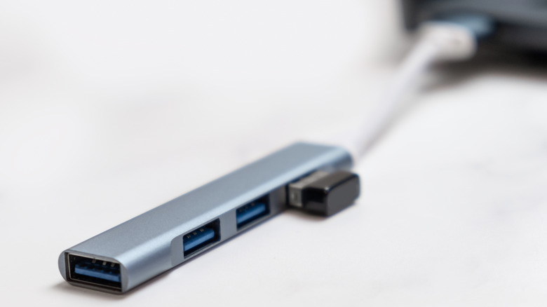 A USB hub for computers sitting on top of a white desk