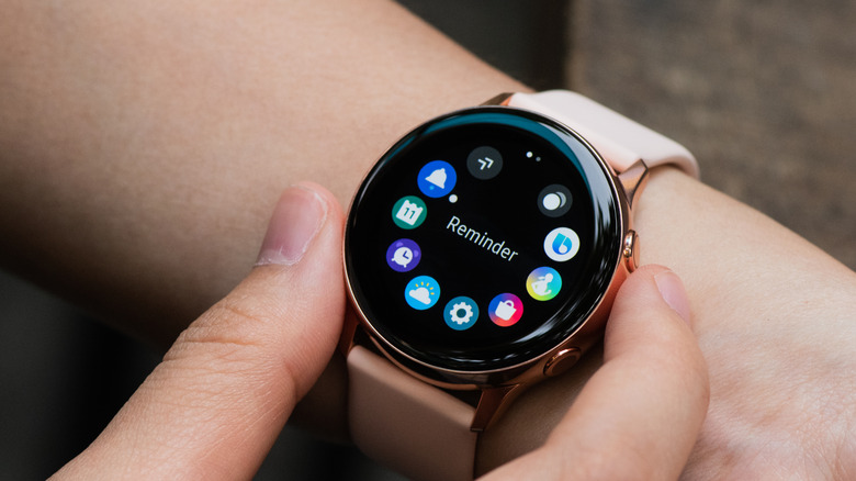 A Samsung Galaxy Watch with several app icons on the screen