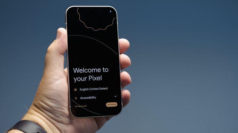 Pixel 9 held in hand showing screen with welcome text