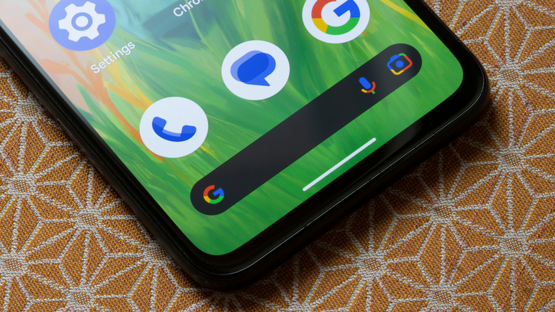 Pixel Phone with screen on laying on orange table cloth