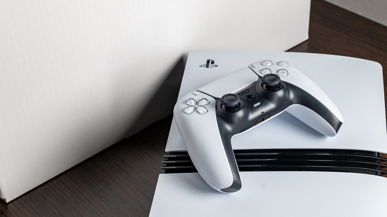 A picture of a DualSense PlayStation controller lying atop a PlayStation 5 Pro