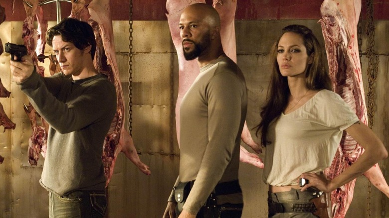 Wesley (James McAvoy), The Gunsmith (Common), and Fox (Angelina Jolie) standing in front of meat in Wanted