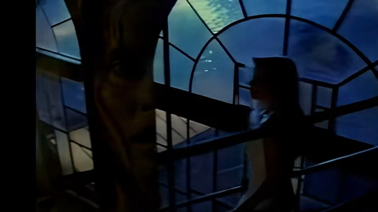 An image of a woman in shadow descending stairs from the TV show VR.5