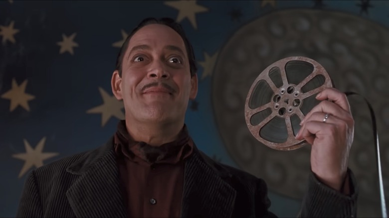 Gomez Addams holding a film reel in The Addams Family