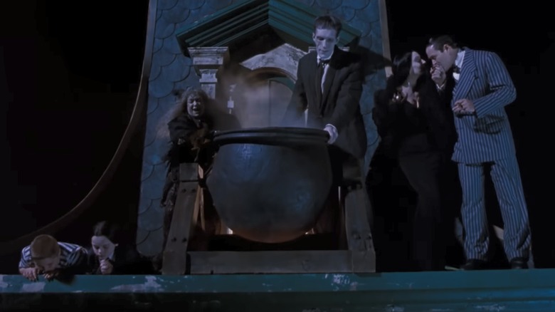 The Addams Family pouring hot oil on carolers