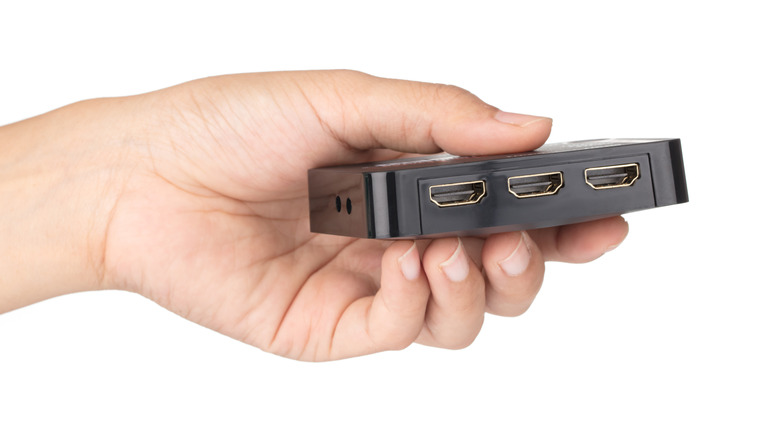 person holding an HDMI switcher