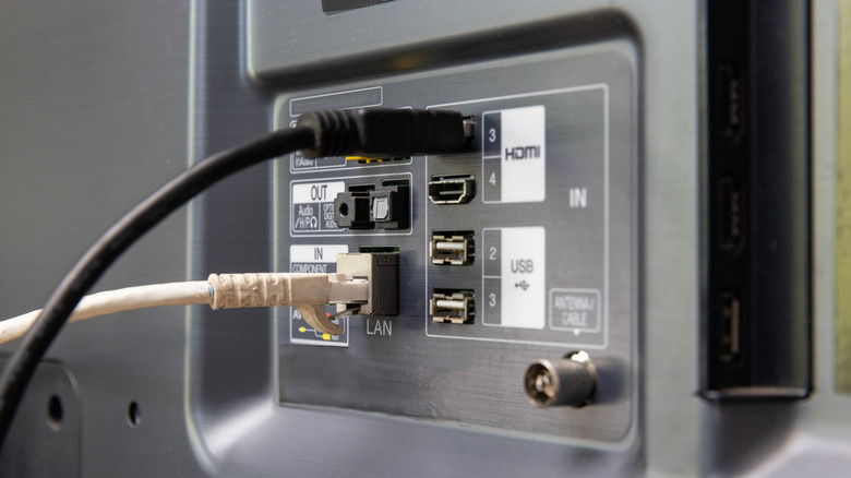 back of a smart tv with a LAN and HDMI cable plugged in
