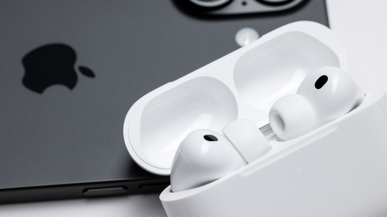 The AirPods Pro 3 next to an iPhone.