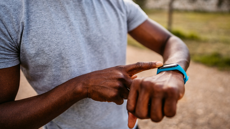 A person checking their heart rate on a smartwatch.