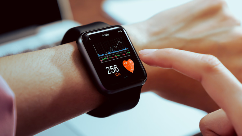 A person wearing a smartwatch tracking health data.