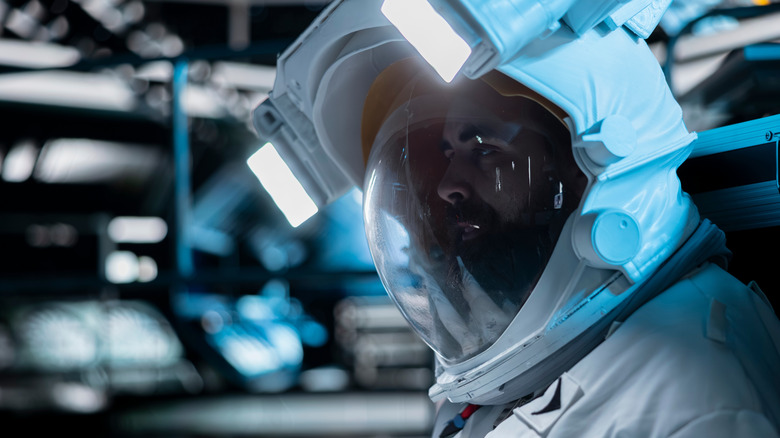 An unhappy-looking man in a space suit.