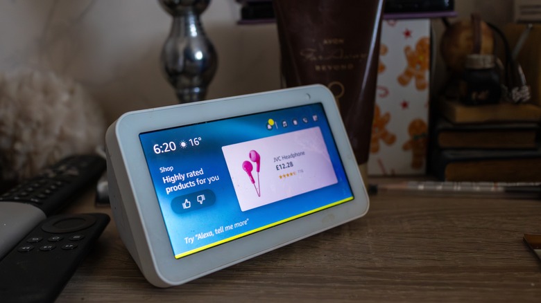An Amazon Echo Show placed on a bedside table.