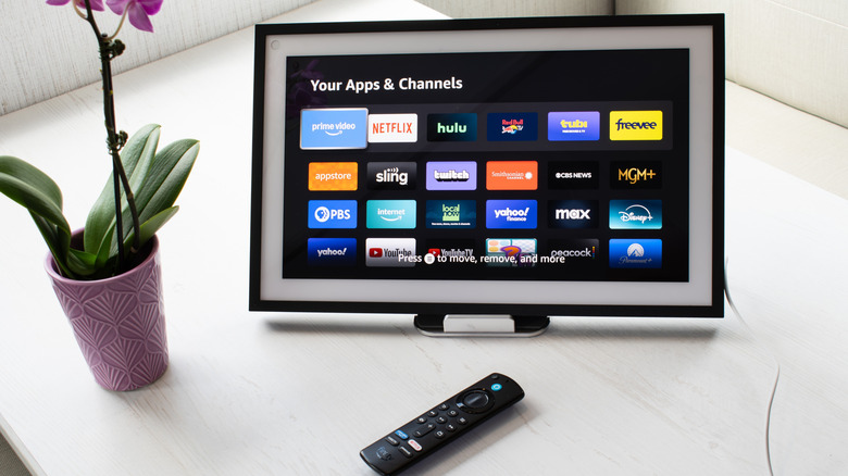 An Amazon Echo Show set up on a table, showing the Your Apps & Channels screen.