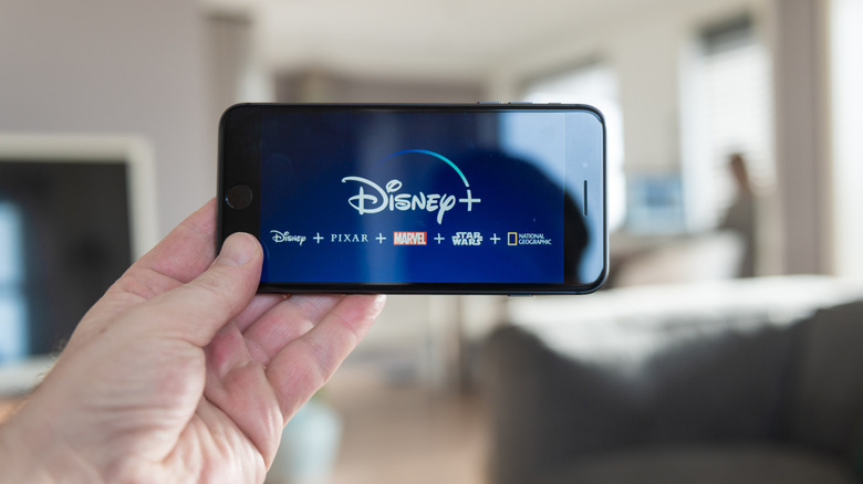 Person watching Disney+ on smartphone