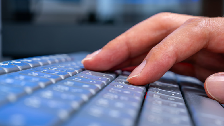 Person typing on a keyboard