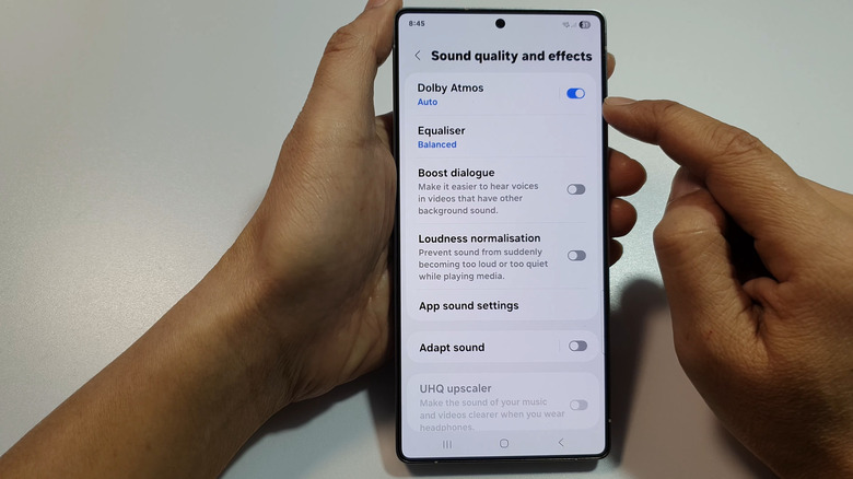 person enabling Dolby Atmos sound on Android smartphone