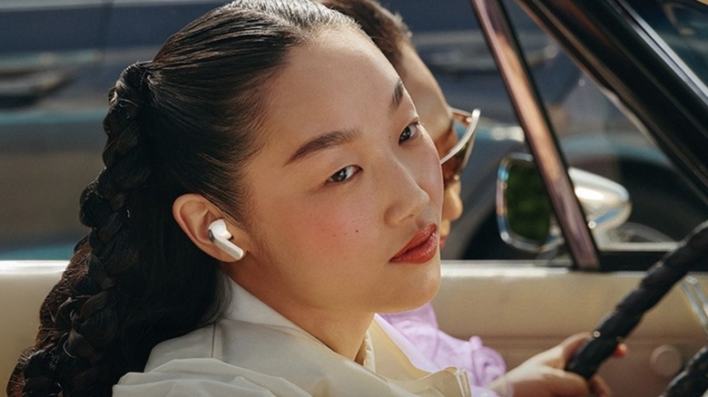 Person wearing Samsung Galaxy Buds 4 Pro while sitting in a car