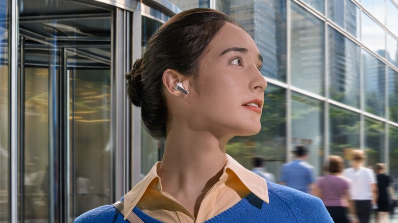 Person wearing Samsung Galaxy Buds 4 Pro while walking outside in a city