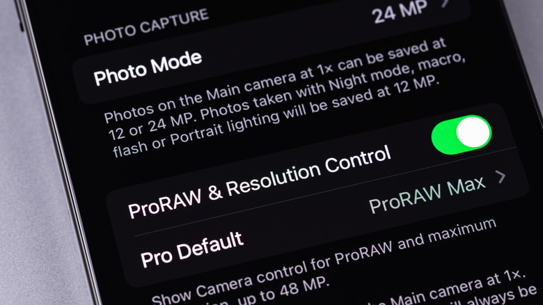 An iPhone with photo capture settings displayed on the screen