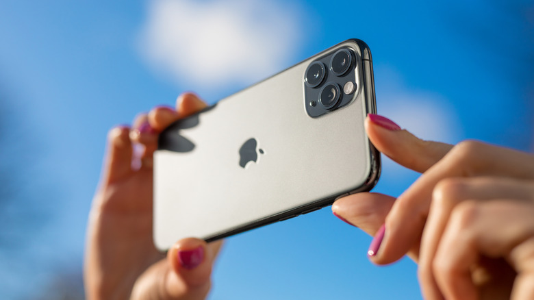 Hands holding an iPhone in a picture-taking position
