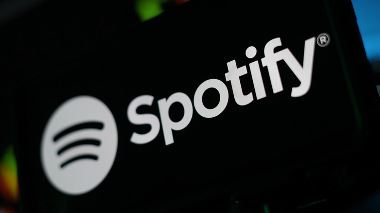 A close-up shot of the Spotify logo on a screen