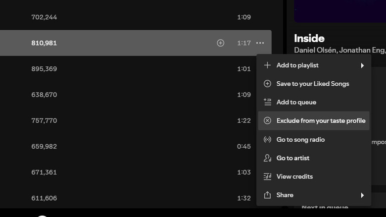 A screenshot of the Spotify desktop app showing a highlighted song in an album. In the dropdown menu beside the song, the option Exclude from your taste profile is highlighted