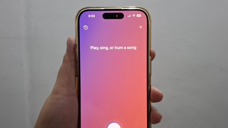 Hand holding phone showing YouTube Music's Sound Search