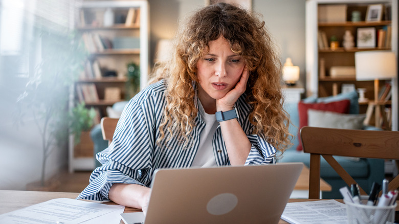 Woman working out a methodology on a laptop while working from home