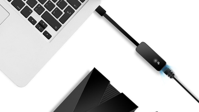 TP-Link UE306 USB to Ethernet Adapter connected to laptop and Ethernet cable