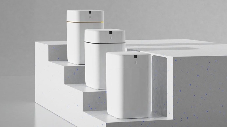 Several smart trash cans on a promotional shot