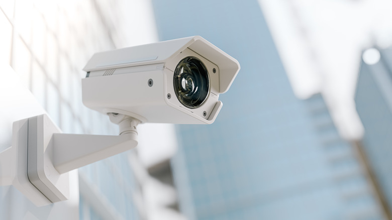 A security camera mounted to the exterior of a building.