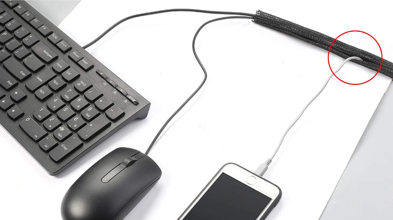 Several cables and devices running through a CrocSee cable management sleeve