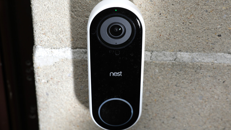 A Nest video doorbell on an outdoor wall.