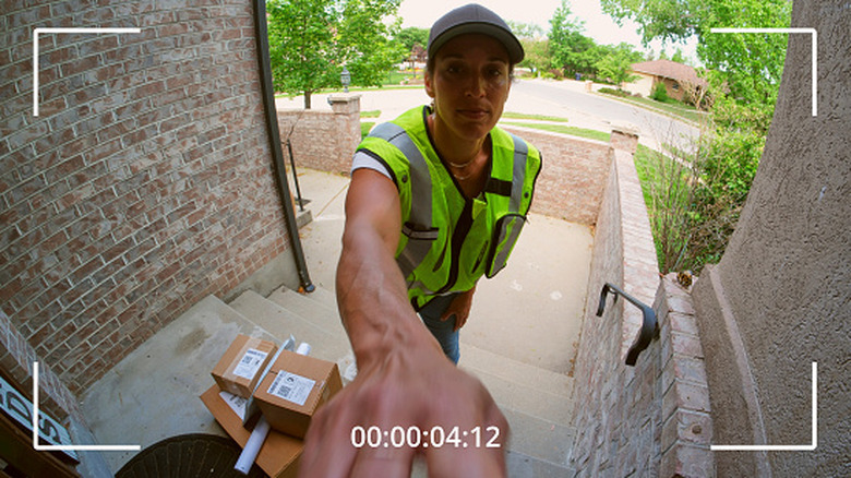 A package courier captured on video by a video doorbell.
