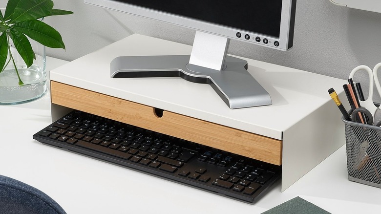 The Elloven Monitor Stand with Drawer placed below a monitor on a desk