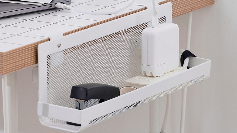 The Forsasong Cable Management Tray mounted to the side of a desk