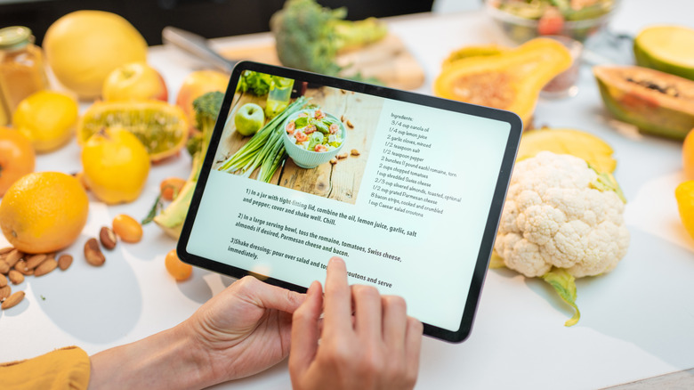 Tablet with food in the background