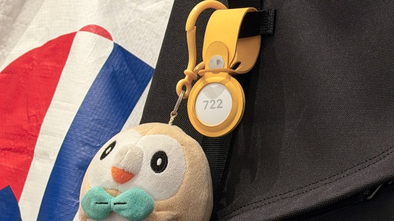 Close-up shot at Apple's AirTag attached to a backpack with a Pokémon plush