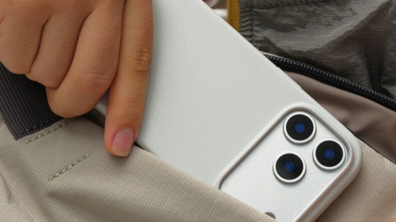 A man putting his iPhone in his pocket