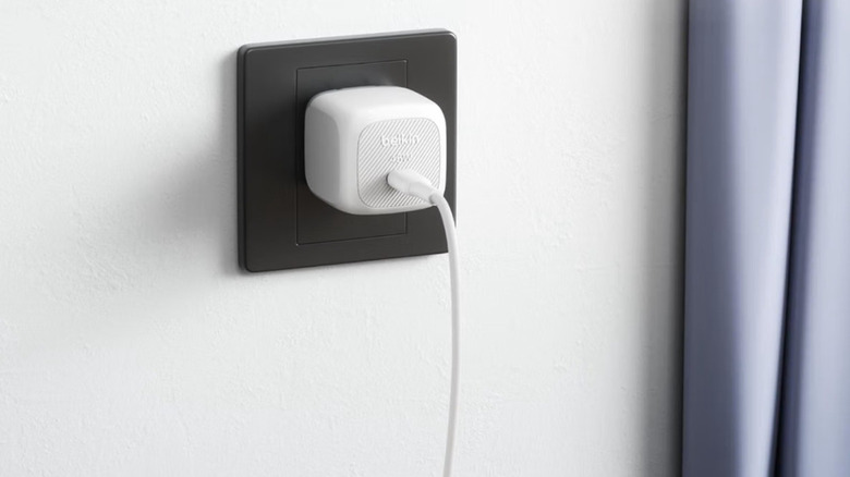 The Belkin BoostCharge Compact Wall Charger plugged into a wall outlet.
