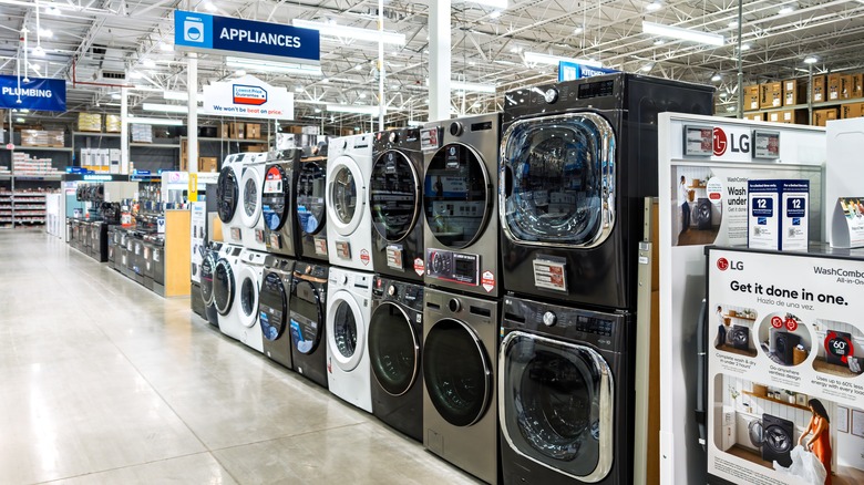 A row of washers and dryers in the appliances department of a large store
