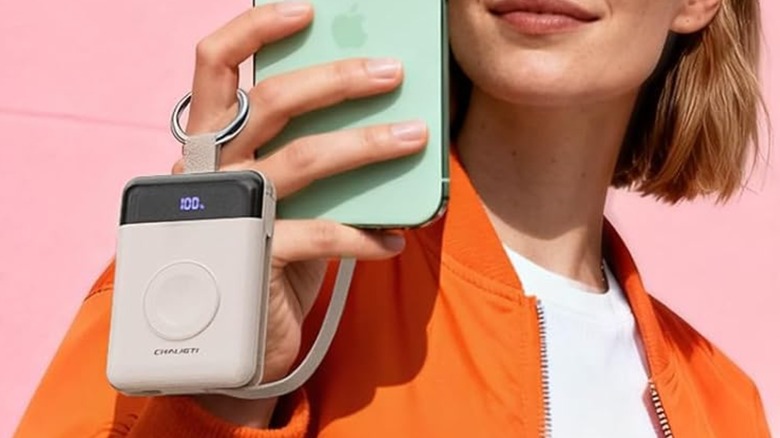 A woman charging a phone with the Chaligti Portable Charger.