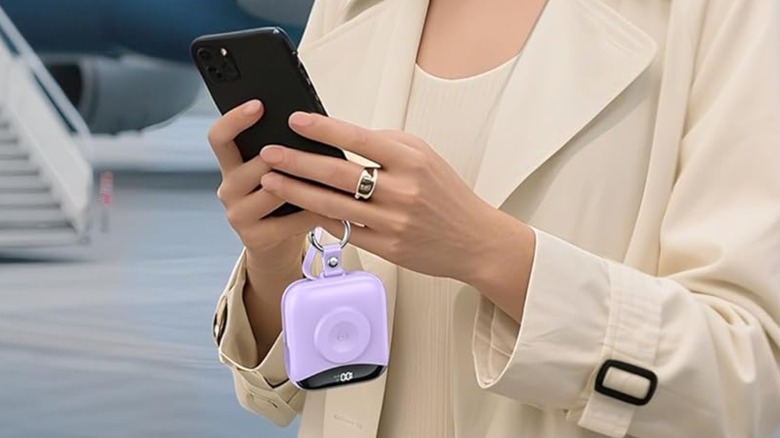 A woman using a phone plugged into a Citicr Portable Charger.