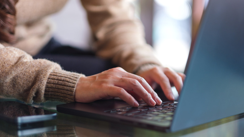 A man using a laptop on a desk
