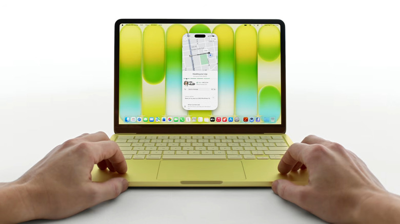 A person using a MacBook Neo with its screen showing the desktop.